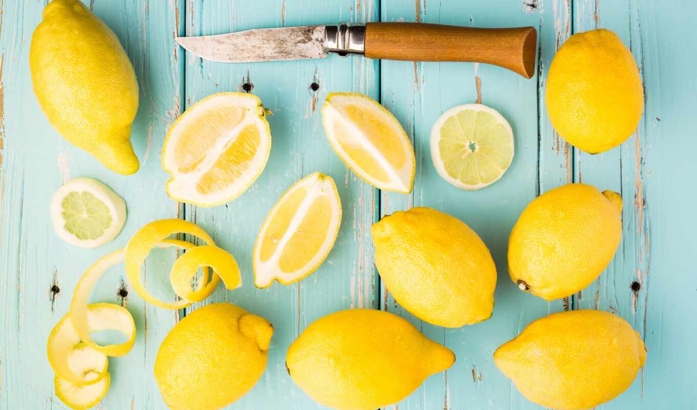 Lemon, knife, wood boards, lemons