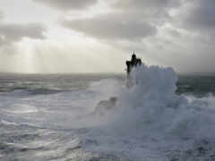 серфер на волне в океане с облачным небом