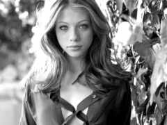 женщина, прислоненная к стене с листовым деревом на заднем плане