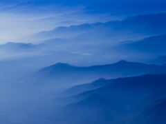 горы видны с самолета, когда он летит над облаками