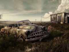 ржавый старый автомобиль в поле с лачугой на заднем плане