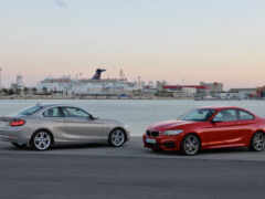 две машины припаркованы рядом друг с другом возле водоема