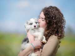 женщина держит щенка на руках