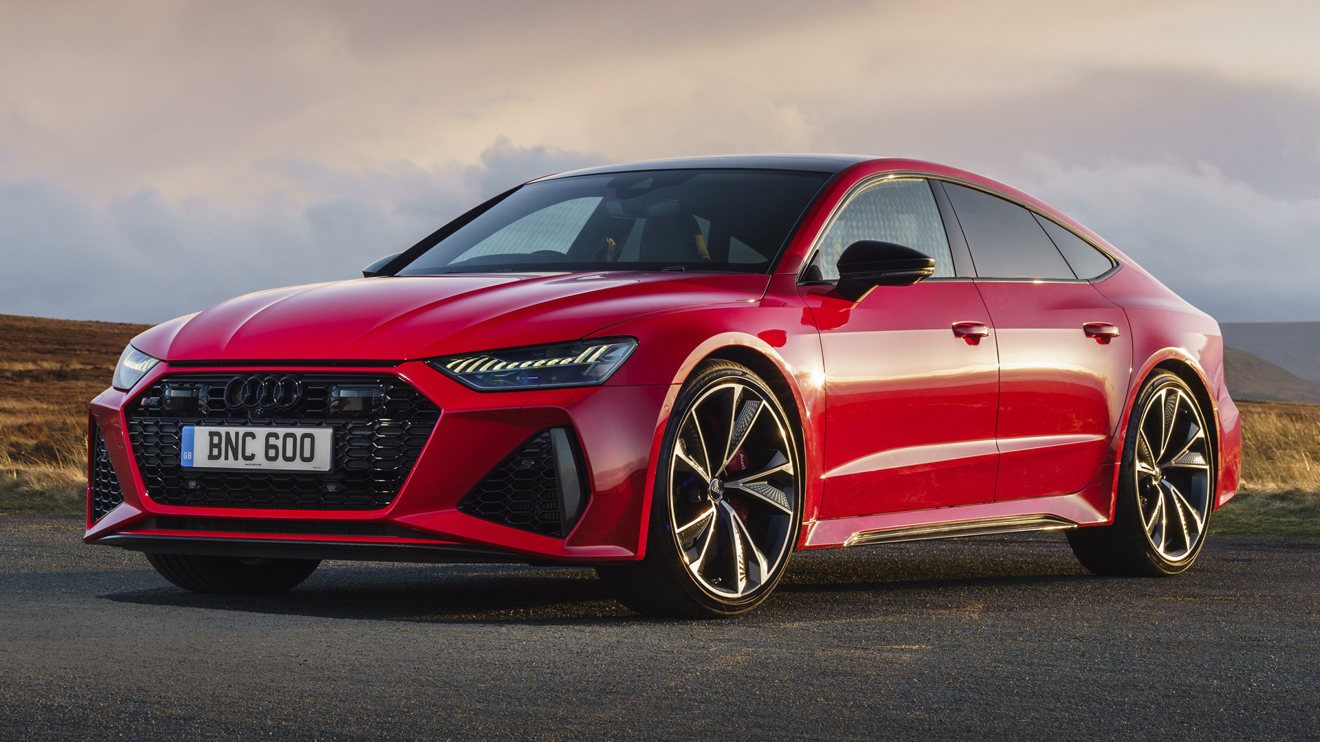 красный audi rs4 припаркован на дороге в горах