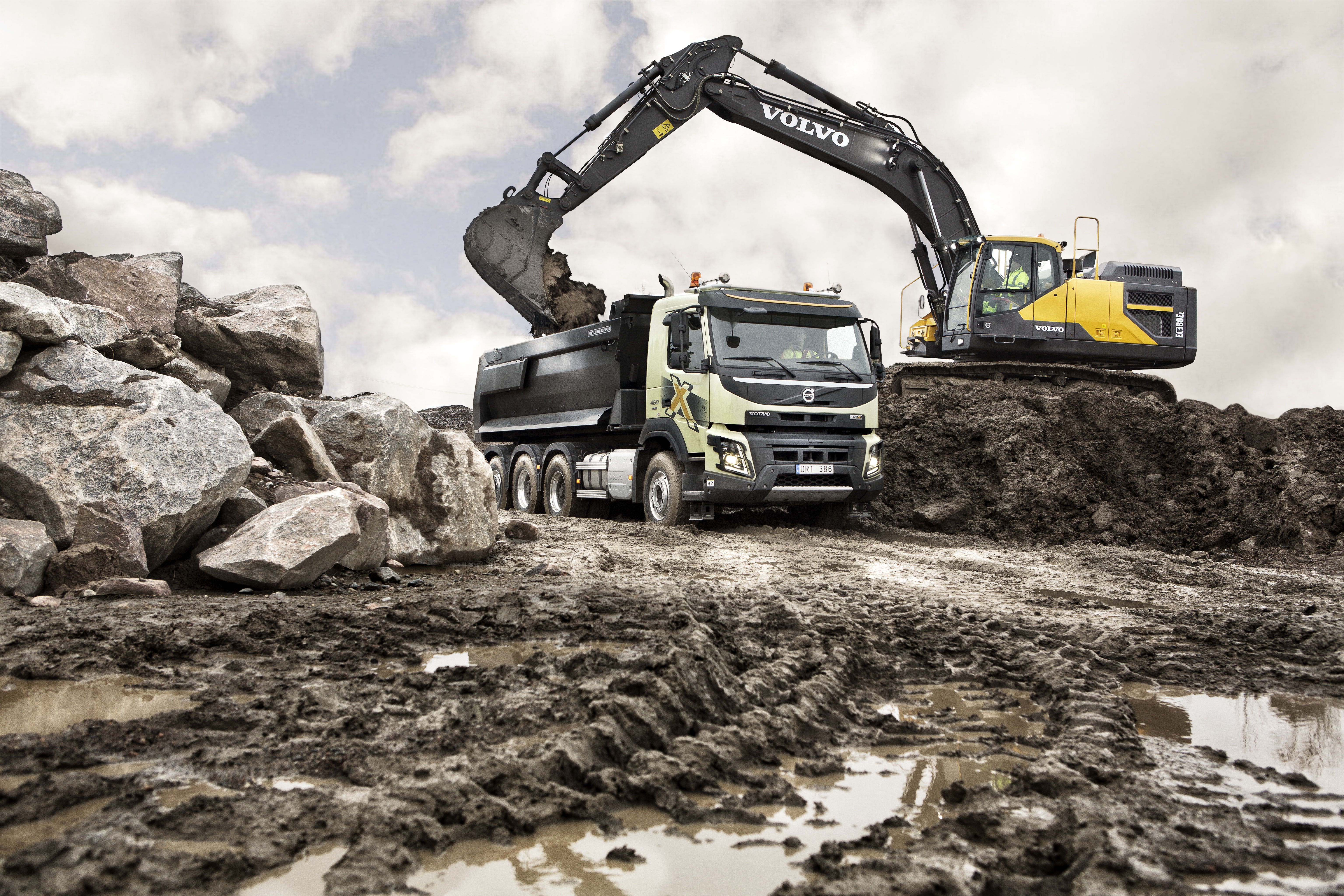 Loading trucks with excavator